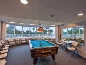 a billiard room with a pool table and chairs at 2 Bedroom 2 bath Condo on the Beach on the 8th Floor in Daytona Beach