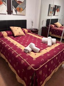 a bedroom with a bed with towels on it at Apartamento Zahara in Zahara de los Atunes