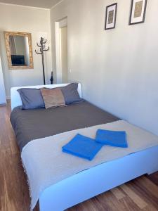 a bed with two blue towels on top of it at CityView Apartment in Tallinn