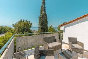 a balcony with patio furniture and a view of the ocean at Hotel Villa Aurora in Crikvenica