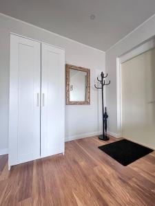 a white room with a cross and a mirror at CityView Apartment in Tallinn