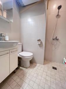 a bathroom with a toilet and a sink and a shower at CityView Apartment in Tallinn