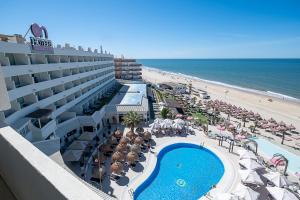 a view of a hotel with a swimming pool and the beach at ON Hotels Oceanfront Adults Designed in Matalascañas