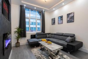 a living room with a couch and a table at Luxurious Duplex in Bolton – Sleeps 6 – Parking in Bolton