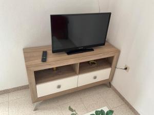 a flat screen tv sitting on top of a cabinet at Apartamentos Turísticos Los LLanos in Cuevas del Almanzora