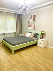 a bedroom with a large bed in a room at 3 bedrooms Spring mood in Almaty