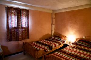 Llit o llits en una habitació de Casa Campo, Casa Rural antigua en Biniés