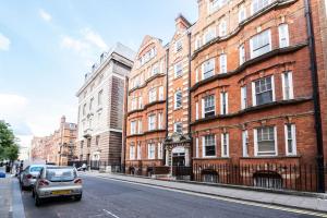 a city street with buildings and a car parked on the street at Bright Studio Flat in the Heart of Marylebone in London