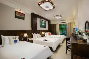 Postel nebo postele na pokoji v ubytování Hanoi Stella Hotel