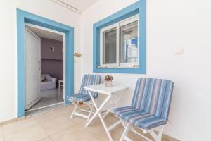 a dining room with two chairs and a table at Akali Apt Next to the Beach in Milatos