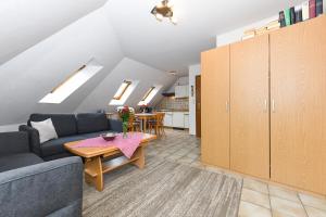 a living room with a couch and a table at Ferienwohnung Elly in Esens