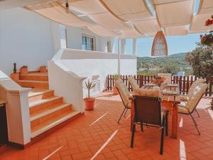 a patio with a table and chairs and stairs at Green Ville in Faro