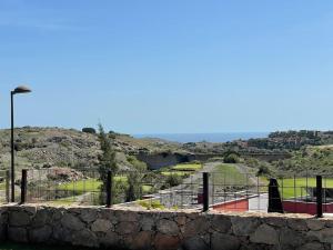 a view of a tennis court in a park at Sea View Villa Vista Golf in Salobre