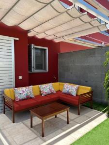 a patio with a couch and a table under awning at Sea View Villa Vista Golf in Salobre +37 photos