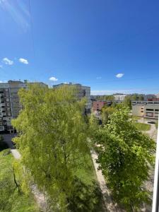 a group of trees in a city with buildings at Ruses. One Bedroom Apartment in Rīga