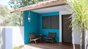 a patio with two chairs and a table at Meno Charm in Gili Meno