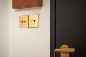 a bathroom door with two pictures on the wall at Citadines Connect City Centre Singapore in Singapore