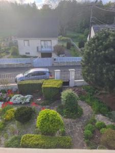 a garden in front of a house with a blue fence at Villa Alice in Blérancourt