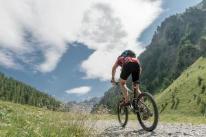a man riding a bike on a mountain road at Hotel Nevada in Samnaun