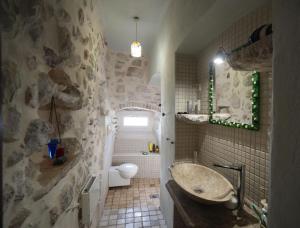 a stone bathroom with a sink and a toilet at Apartment Dyonis Perast in Perast +41 photos