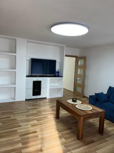 a living room with a blue couch and a coffee table at Wiking in Turawa