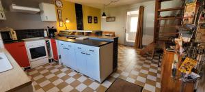 a kitchen with a stove and a sink in it at Entre Ciel et Marais in Graignes