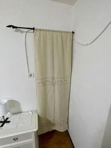 a curtain is hanging in a room with a desk at Casa vacanze Da Meryon in Albiano