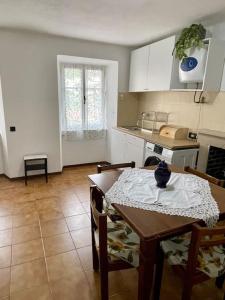 a kitchen with a table and a table and chairs at Casa vacanze Da Meryon in Albiano