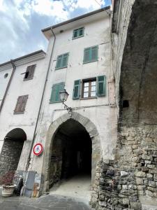 a stone building with an archway in front of it at Casa vacanze Da Meryon in Albiano