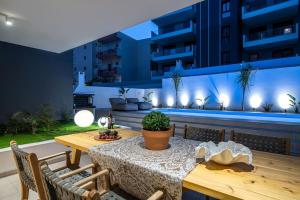 a patio with a table and chairs and a building at Assos Aqua Apartment in Heraklio Town