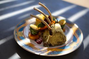 a plate of food with vegetables on a table at Oase by 7 Star Lodges - Greater Kruger Private 530ha Reserve in Hoedspruit