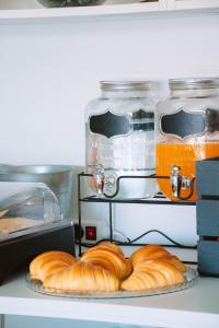 two plates of croissants on a shelf in a kitchen at Arca Nova Guest House & Hostel Caminha in Caminha