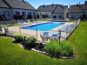 a fence around a swimming pool in a yard at Le 4 Saisons 3 in Beaupré