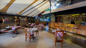 a restaurant with tables and chairs and a bar at Warwick Centre Furnished and Serviced Apartments in Nairobi