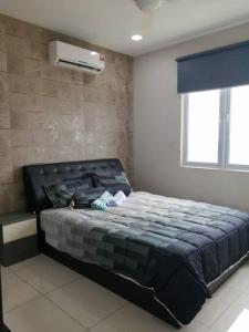 a bedroom with a bed and a air conditioner at Aurora Residence @ PUCHONG PRIMA in Puchong