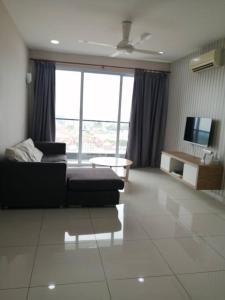 a living room with a couch and a tv at Aurora Residence @ PUCHONG PRIMA in Puchong