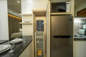 a kitchen with a stainless steel refrigerator with a microwave at Modern & comfy studio in central Jakarta, SCBD in Jakarta