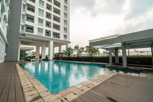 a swimming pool in front of a building at Modern & comfy studio in central Jakarta, SCBD in Jakarta