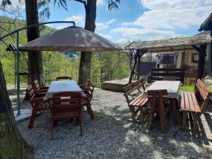 a group of tables and chairs under an umbrella at Vila Viorica in Sovata
