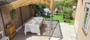 a patio with a table and a fence at Dana Paradise House in Nice