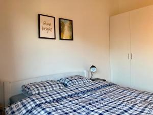 a bedroom with a blue and white bed with two pillows at Baltica Mielenko - domki apartamentowe nad morzem in Mielenko