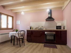 a kitchen with a table and a stove top oven at Casa Rural Picu Llagos in Cangas de Onís