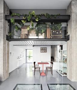 a dining room with a table and chairs at Rosso Segnale Milano in Milan