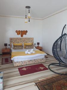 a bedroom with a king sized bed and a chair at villaluna in Tangier