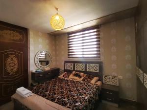 a bedroom with a bed and a window in it at Top "OverView" Resort اطلالة القمة in Al ‘Āmirīyah +36 photos