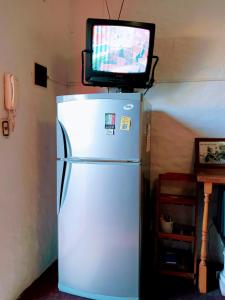 a white refrigerator with a tv on top of it at Casargentina Apart Depto entero Baño privado 15min Ezeiza in Monte Grande