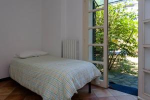 a bedroom with a bed and a window at Pupetta Garden in Sori