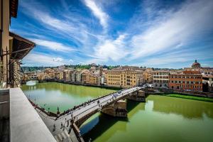 a bridge over a river in a city at Rivalta Hotel - Alfieri Collezione in Florence