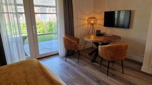 TV a/nebo společenská místnost v ubytování B&B De Droomhoeve