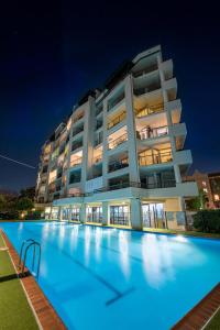 a large building with a swimming pool at night at Goldsborough Place Apartments in Brisbane